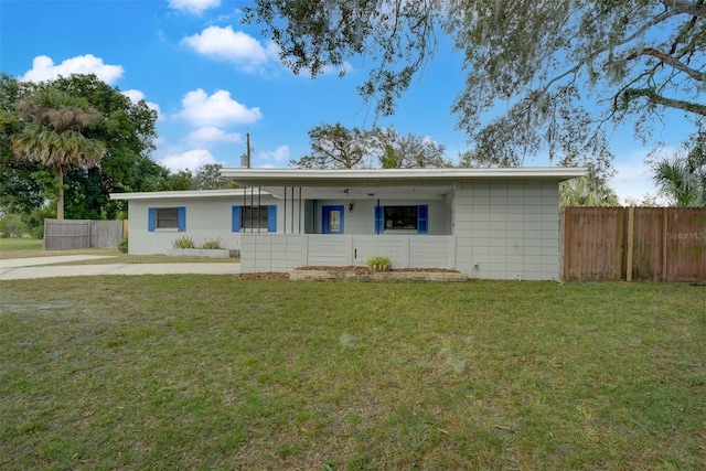 ranch-style home with a front lawn