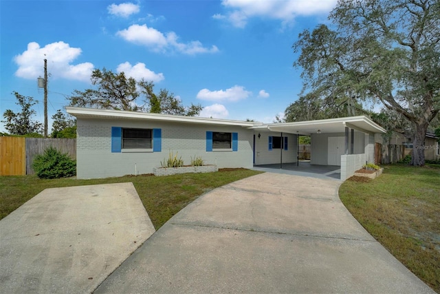 single story home with a front yard and a carport