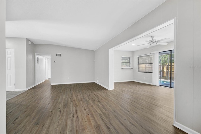 unfurnished living room with dark wood-type flooring and ceiling fan