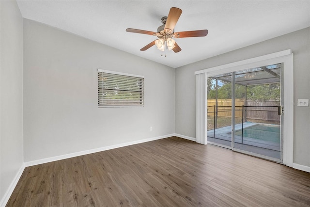 unfurnished room featuring vaulted ceiling, dark hardwood / wood-style floors, and ceiling fan