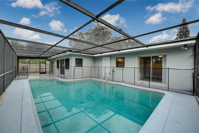 view of pool with a patio area and a lanai