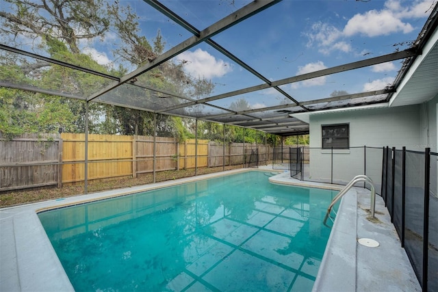 view of pool featuring glass enclosure