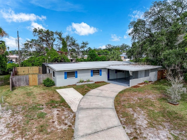 ranch-style house with a carport and a front yard