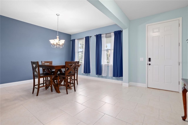 dining room with light tile patterned floors and a notable chandelier