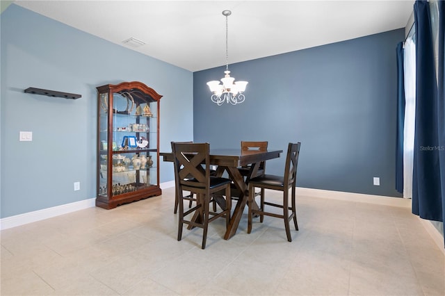 dining space featuring a chandelier and light tile patterned floors