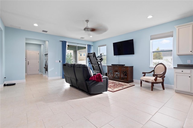 living room with ceiling fan and light tile patterned floors