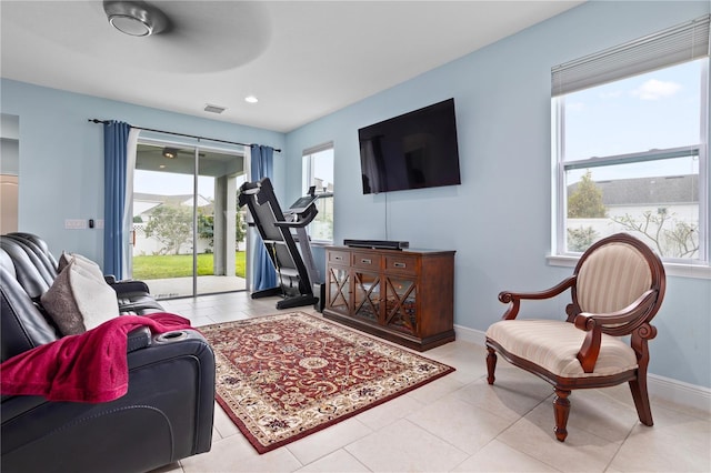 living room with ceiling fan and light tile patterned floors