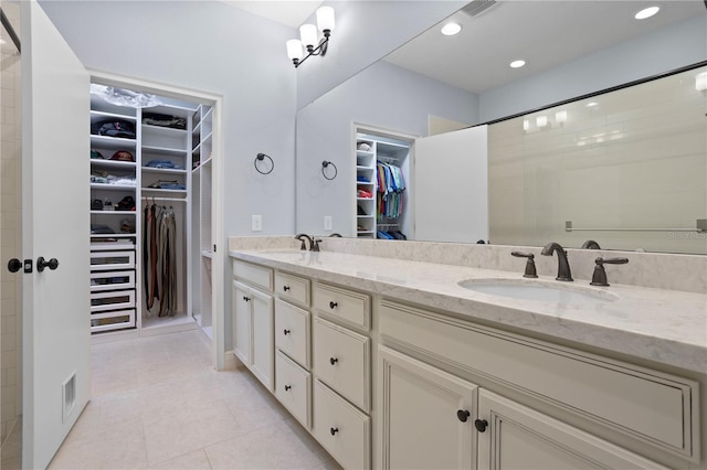 bathroom featuring tile patterned flooring and vanity