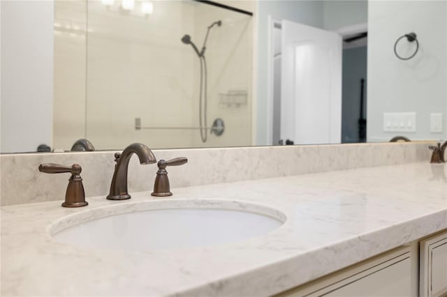 bathroom featuring a shower and vanity