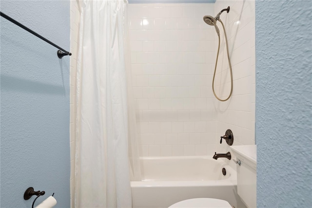 bathroom with shower / bath combination with curtain and toilet