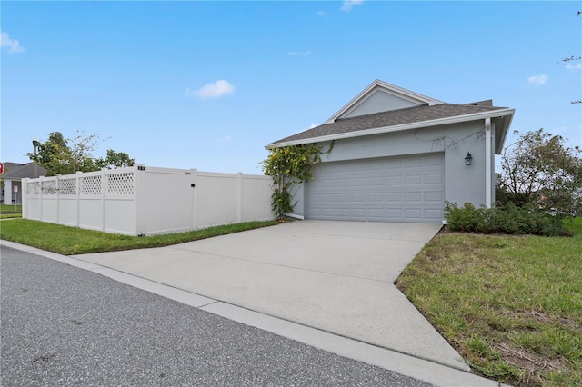 view of side of home featuring a yard and a garage