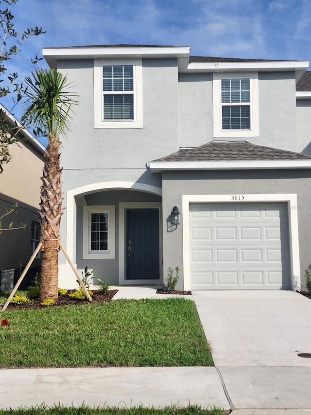 front of property with a front lawn and a garage