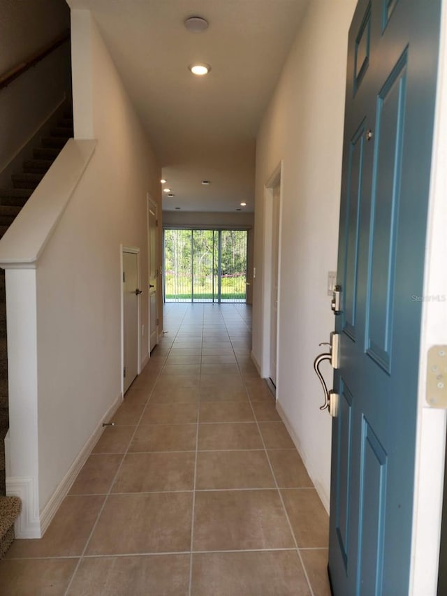 corridor with light tile patterned floors