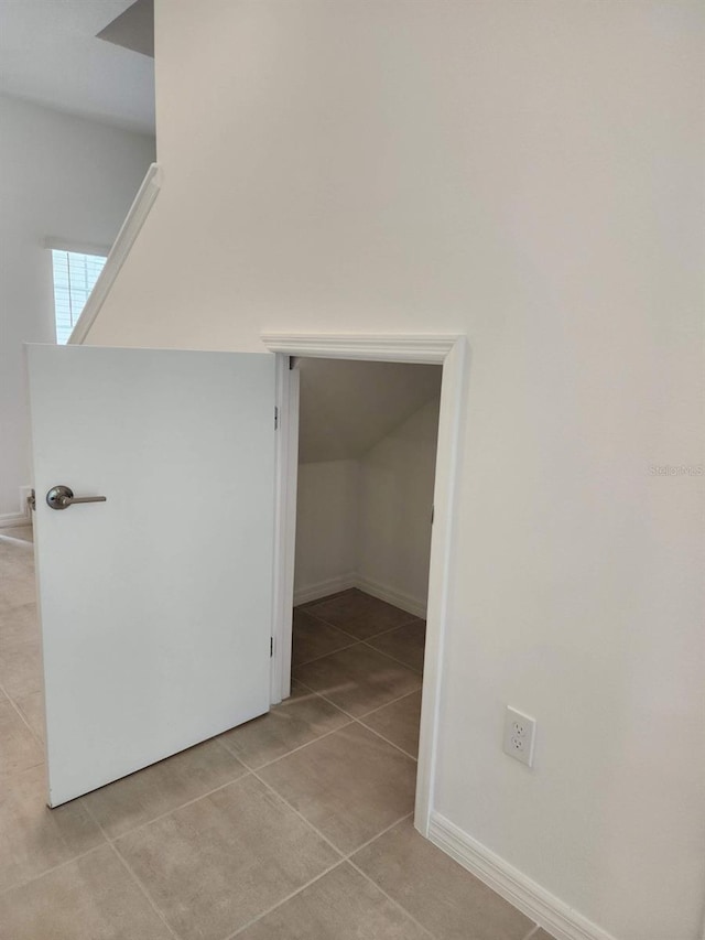 hall featuring light tile patterned floors