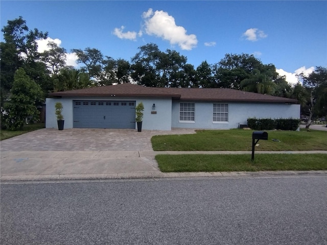 ranch-style house with a front lawn and a garage