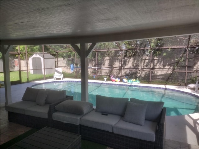 view of pool with an outdoor hangout area, a shed, and a lanai