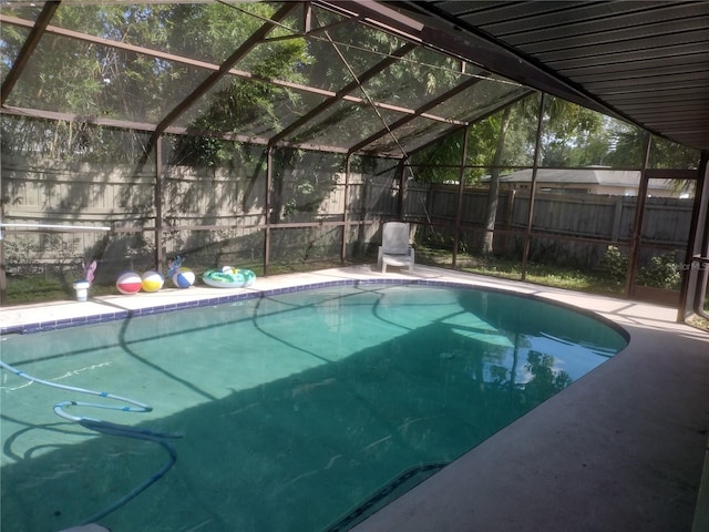 view of pool featuring glass enclosure