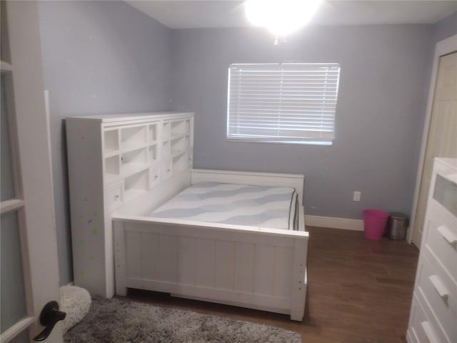 unfurnished bedroom featuring dark wood-type flooring