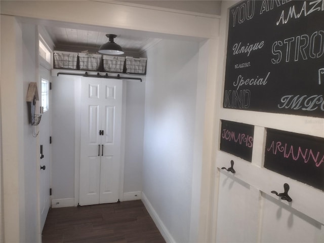 doorway to outside with crown molding and dark hardwood / wood-style floors