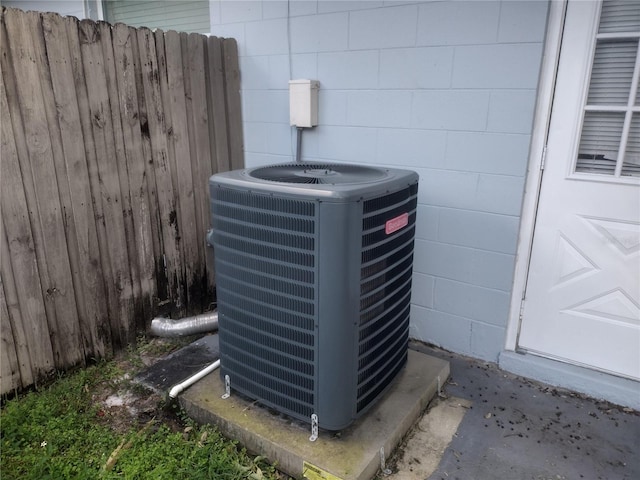 exterior details featuring cooling unit and concrete flooring