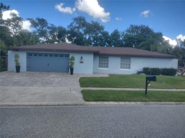 ranch-style home with a front yard and a garage