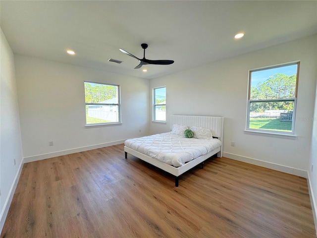 bedroom with hardwood / wood-style floors and ceiling fan