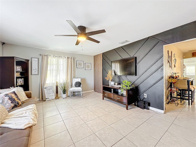 living room featuring light tile patterned floors and ceiling fan