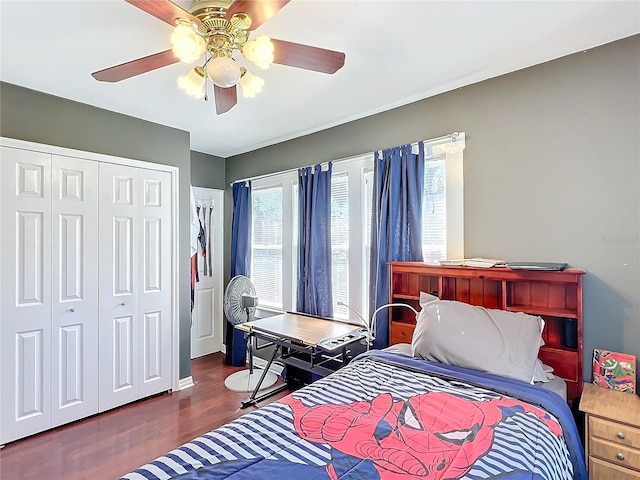 bedroom featuring ceiling fan, a closet, and dark hardwood / wood-style flooring