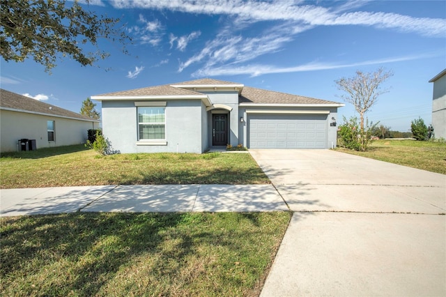 view of front of house featuring a front yard, central AC unit, and a garage