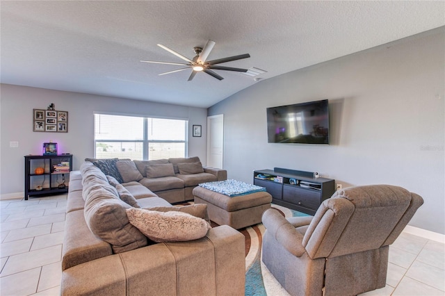 tiled living room with ceiling fan, a textured ceiling, and lofted ceiling