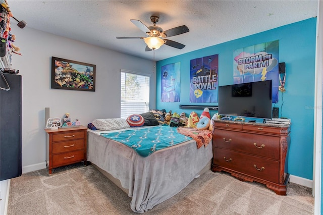 carpeted bedroom with a textured ceiling and ceiling fan