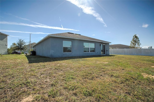 back of house featuring a yard