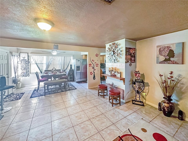 interior space with ceiling fan and a textured ceiling