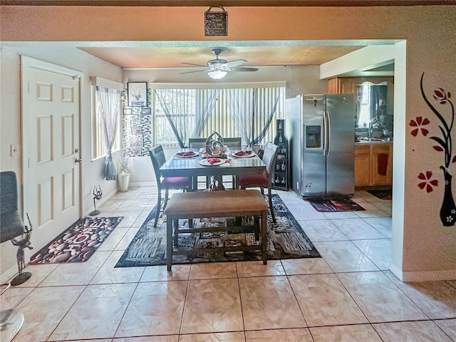 tiled dining area featuring ceiling fan