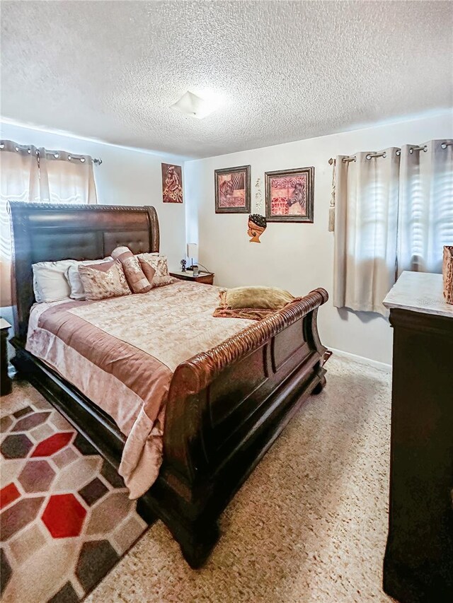 carpeted bedroom with a textured ceiling