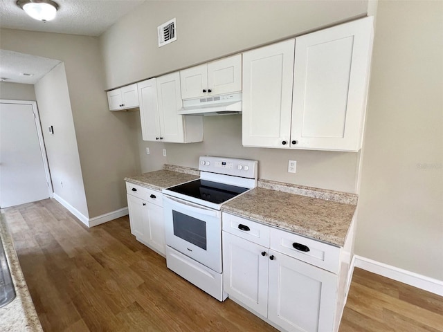 kitchen featuring light hardwood / wood-style flooring, white cabinetry, a textured ceiling, and electric stove