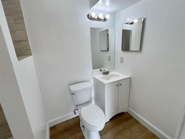 bathroom featuring vanity, toilet, and wood-type flooring