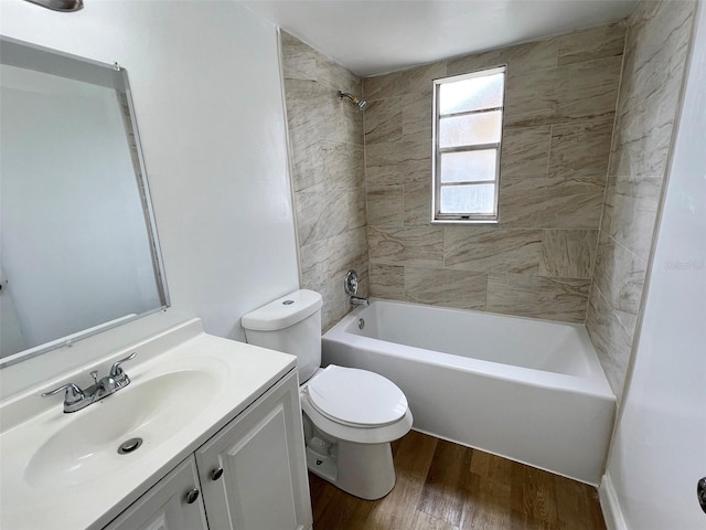 full bathroom featuring vanity, toilet, tiled shower / bath, and hardwood / wood-style floors