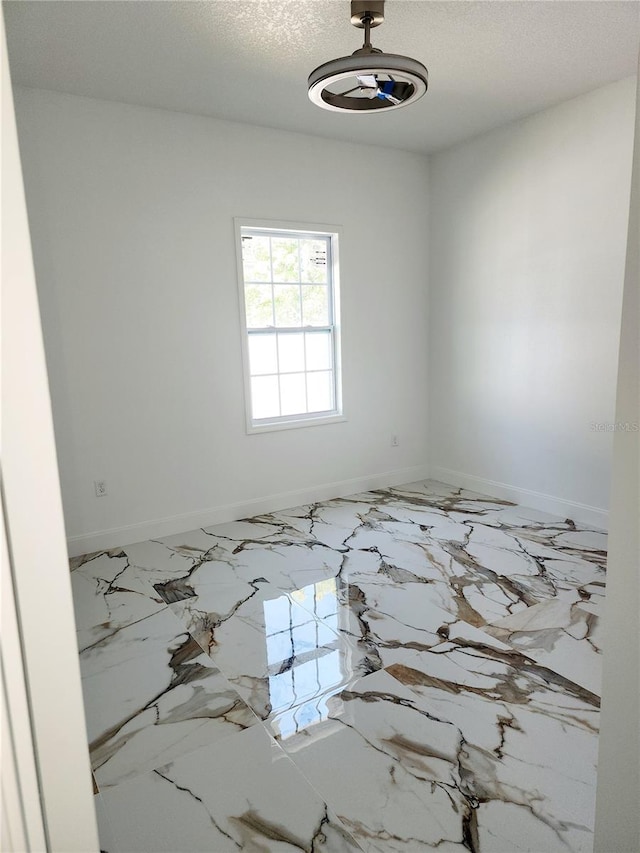 empty room featuring a textured ceiling