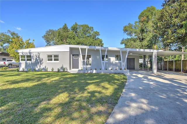 view of front of property with a front lawn, covered porch, and a carport