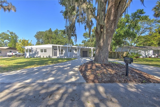 view of front of property featuring a garage and a front lawn