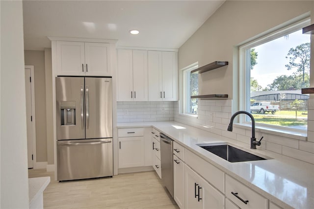 kitchen featuring stainless steel appliances, sink, and a wealth of natural light