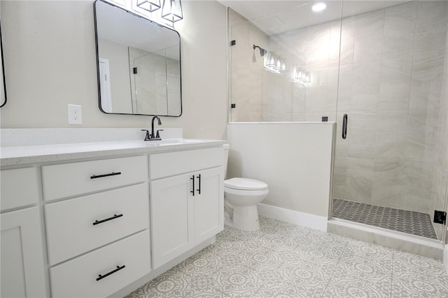 bathroom with vanity, tile patterned flooring, toilet, and walk in shower