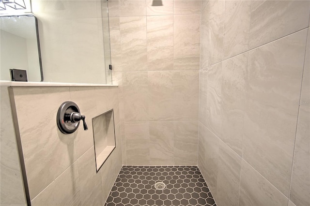 bathroom featuring tiled shower and tile patterned floors