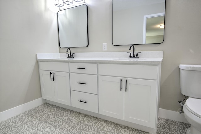 bathroom with vanity, toilet, and tile patterned floors