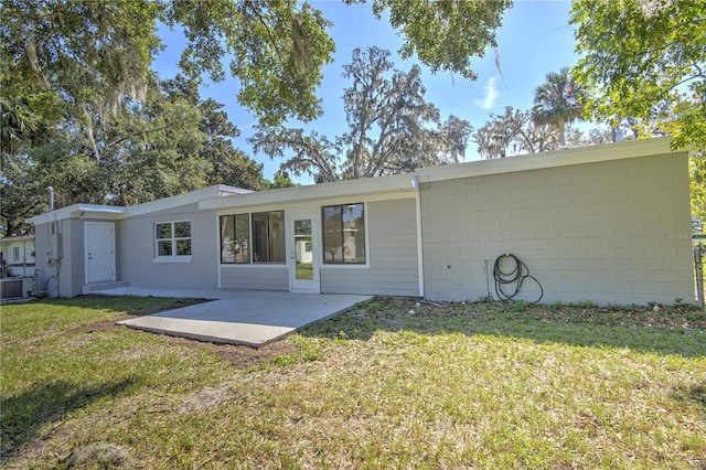 back of property featuring central AC, a yard, and a patio area