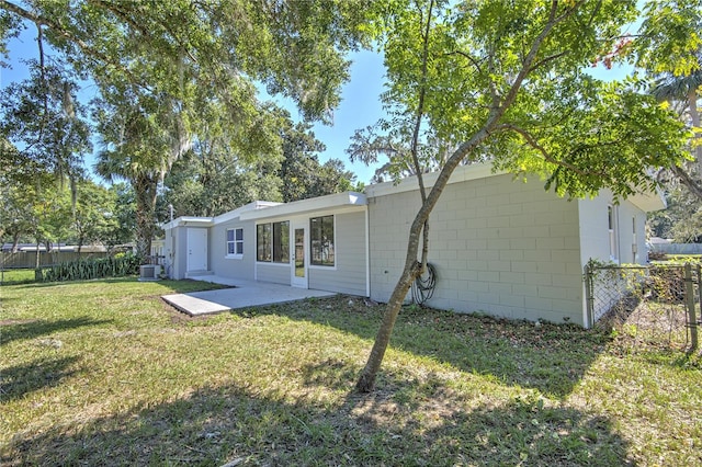 rear view of property with a yard and a patio