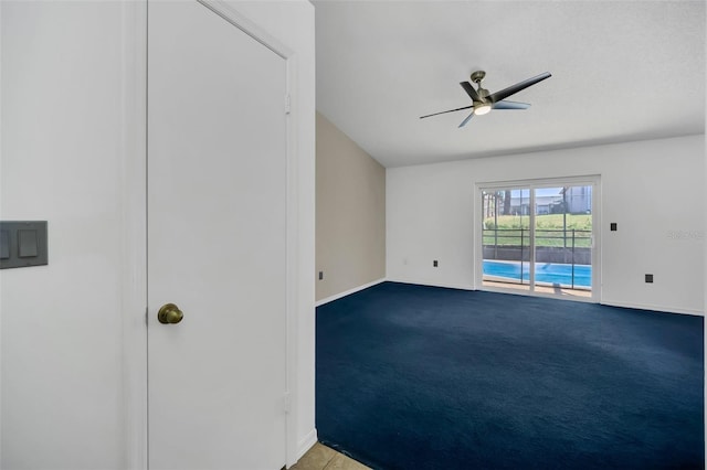 spare room featuring light colored carpet and ceiling fan