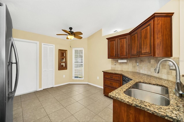 2204 Clementine Trl, Clermont, FL 34714 - kitchen featuring a sink, freestanding refrigerator, ceiling fan, stone counters, and backsplash