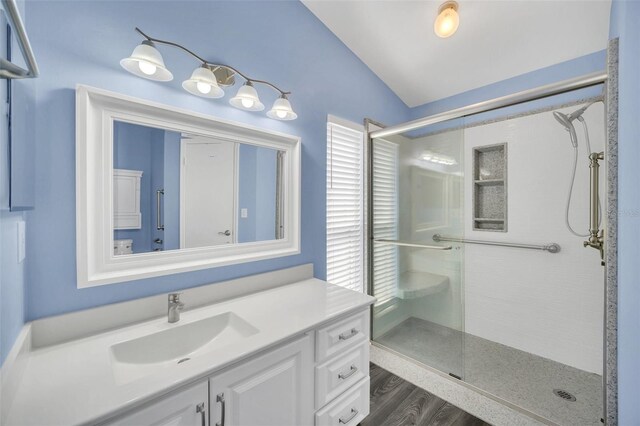 2204 Clementine Trl, Clermont, FL 34714 - full bath with vaulted ceiling, a stall shower, vanity, and wood finished floors